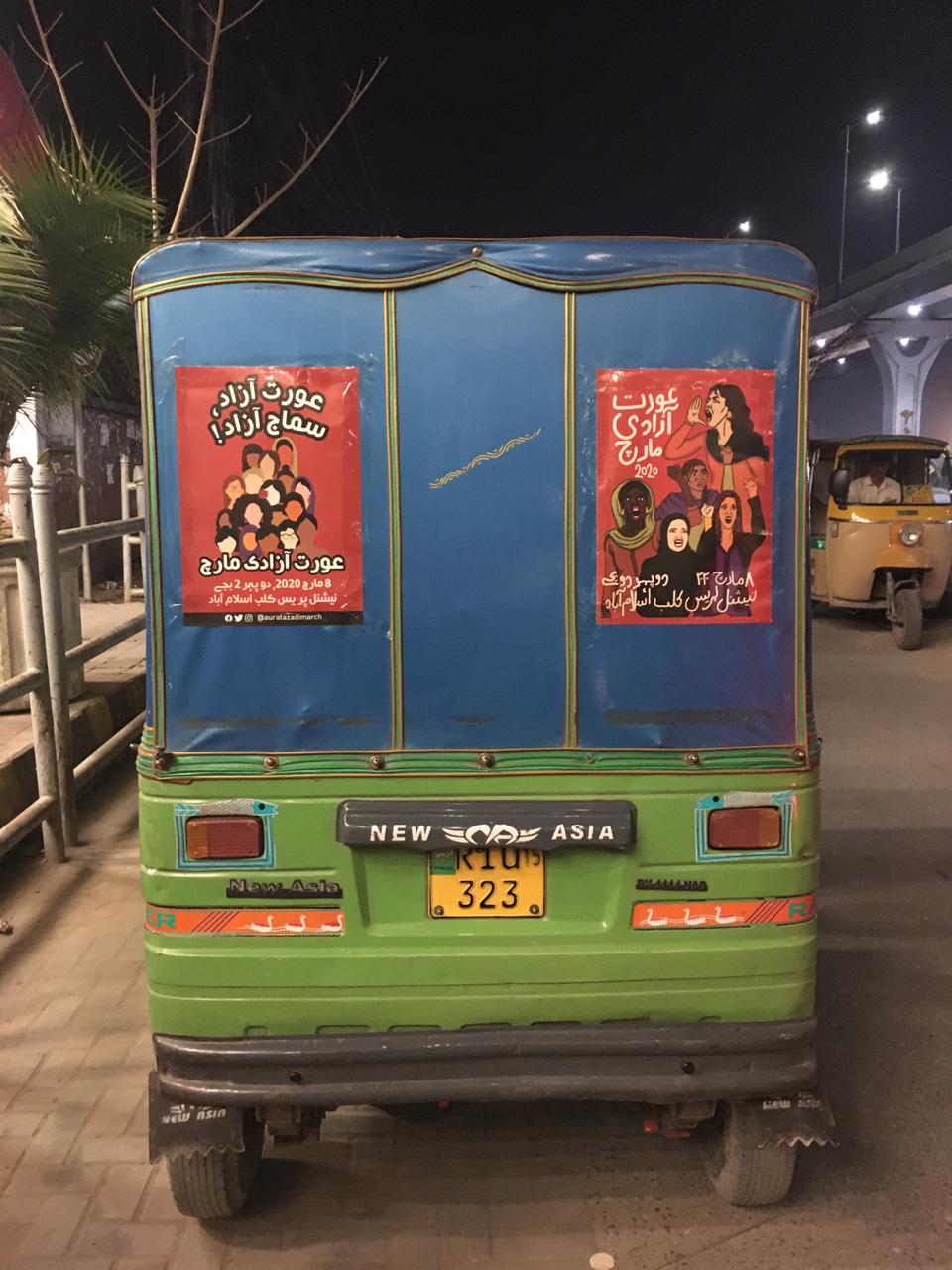Posters travelling on the back of a rickshaw.