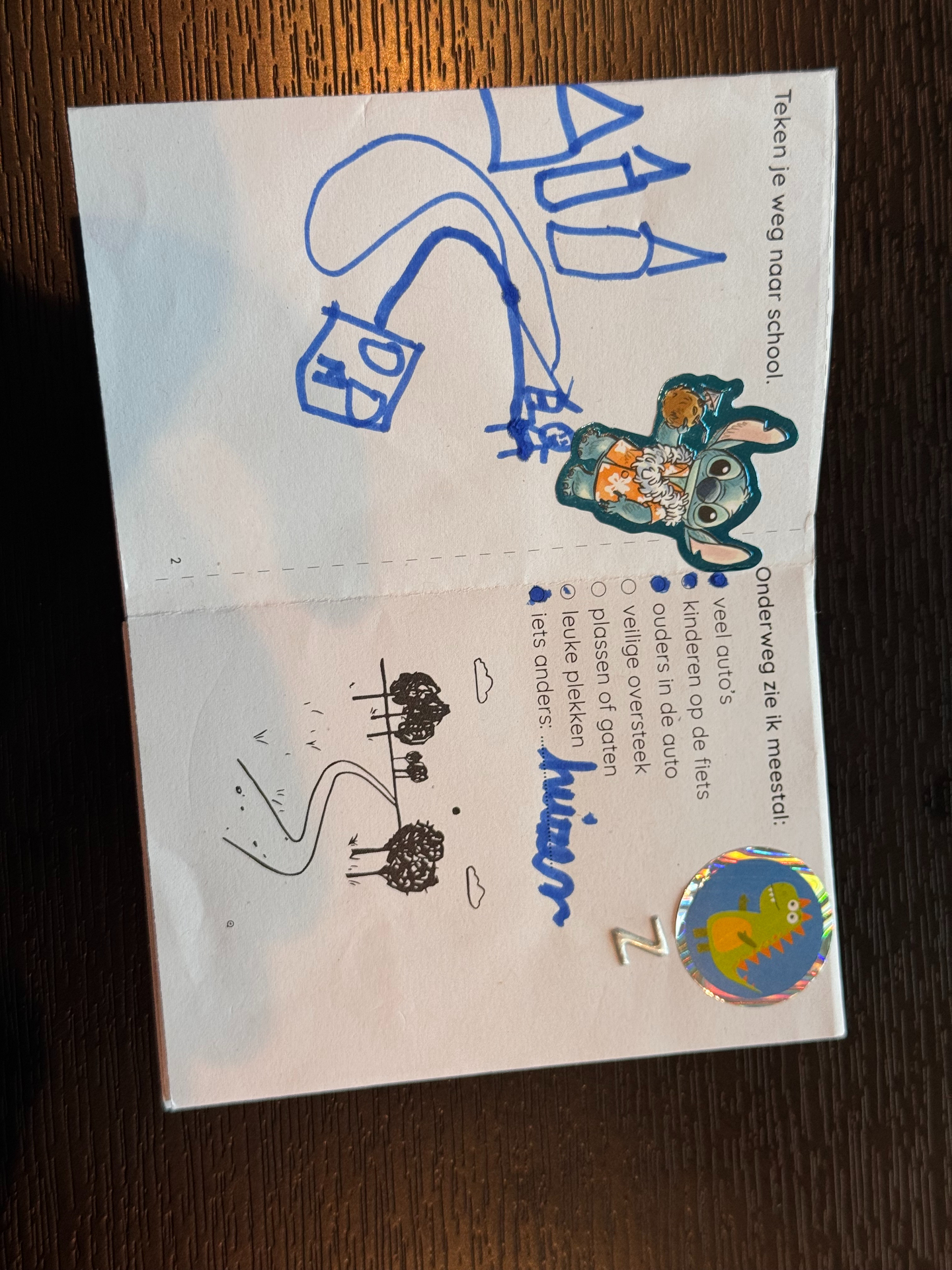 Inside spread with a Stitch sticker and drawing of houses
